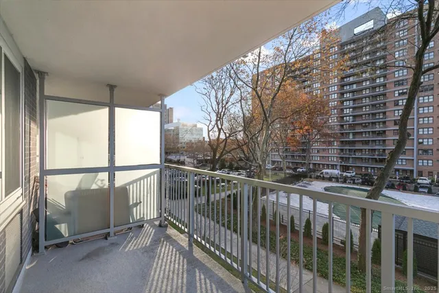 a view of a balcony with wooden floor and fence