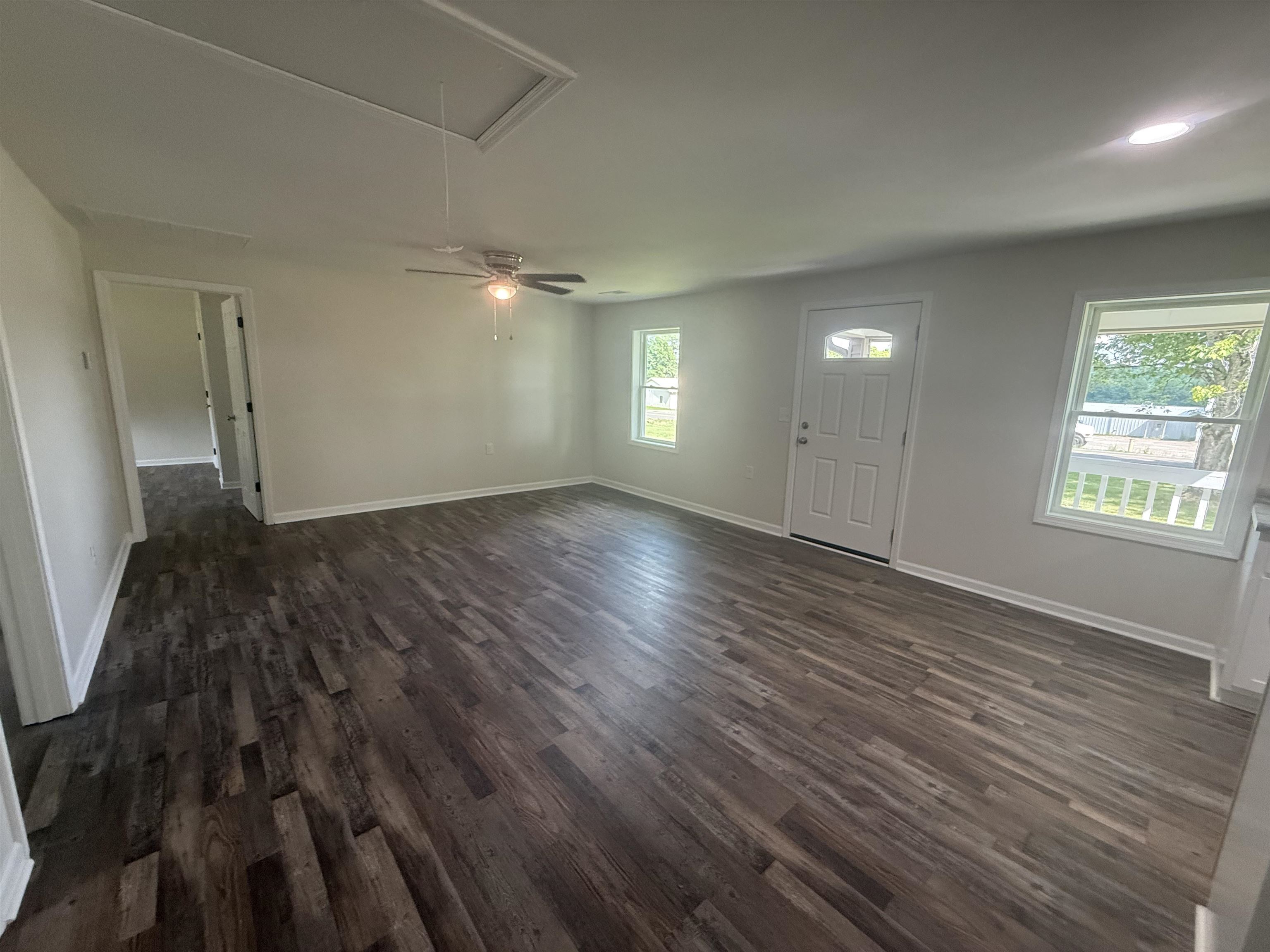 170 Leapwood Road Enville, TN 38332 - Photo 7 of 33 Spacious interior featuring wood-finish flooring, white walls, and bright windows