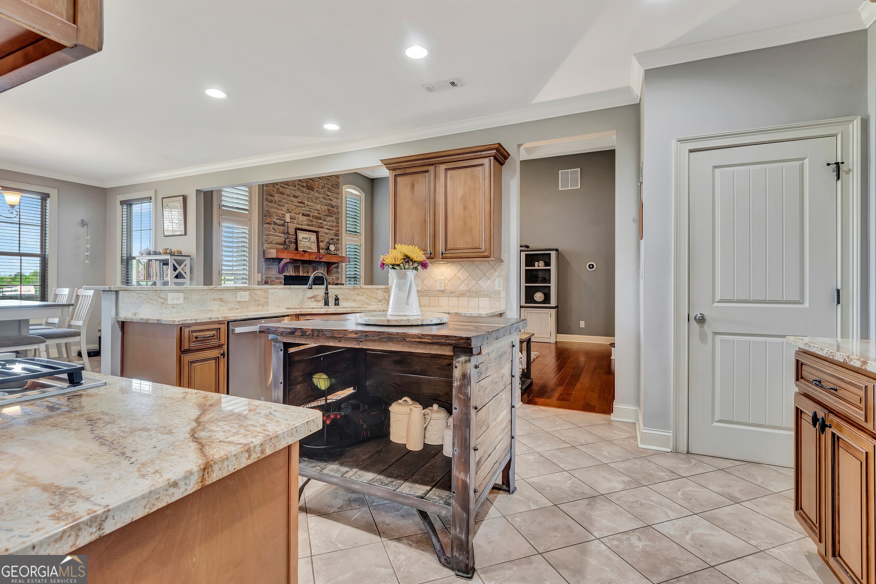 357 Brooks Road Brooks, GA 30205 - Photo 14 of 64 a open kitchen with stainless steel appliances granite countertop a stove top oven a sink a dining table and chairs