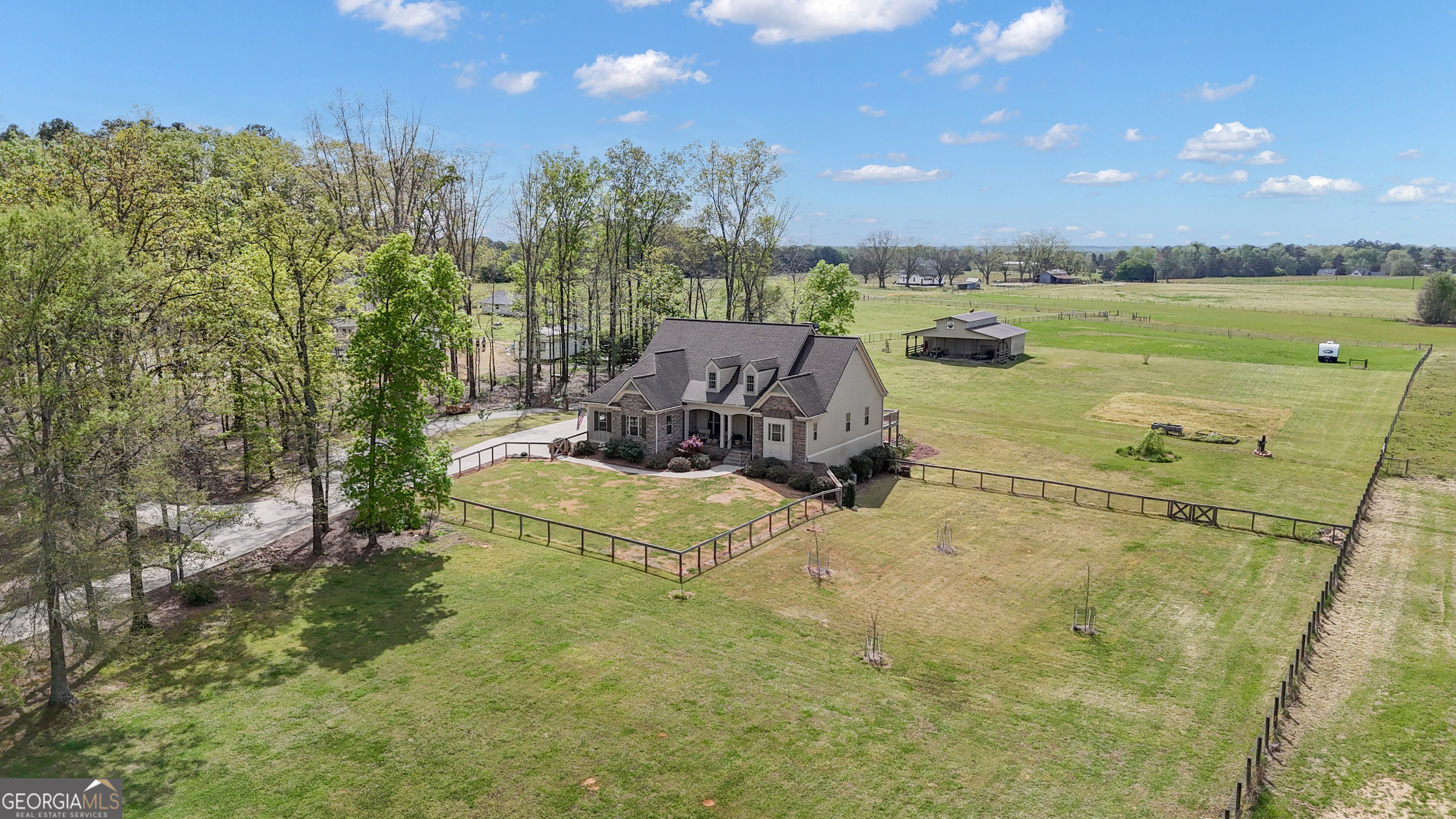 357 Brooks Road Brooks, GA 30205 - Photo 2 of 64 a view of a lake with a house in the background