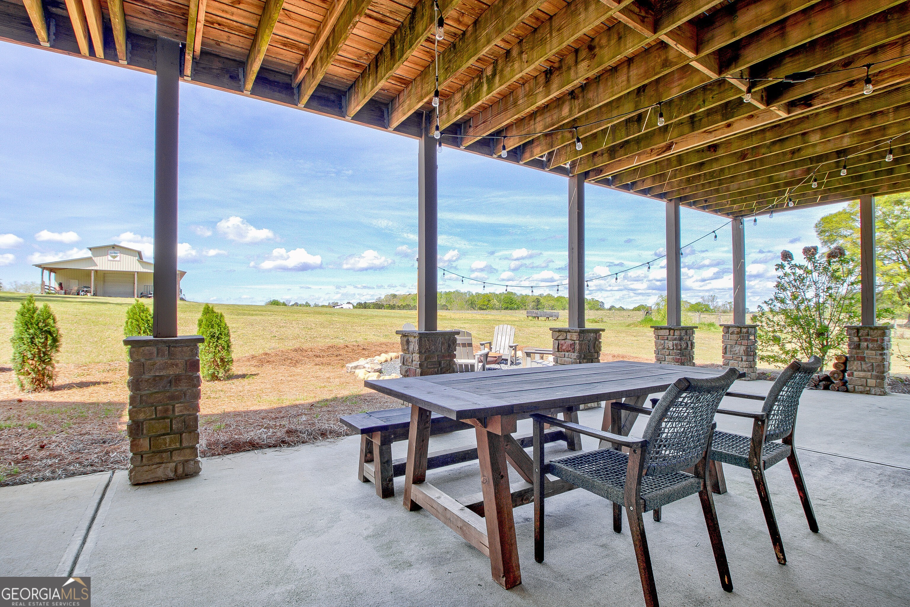357 Brooks Road Brooks, GA 30205 - Photo 45 of 64 a view of a patio with a table chairs and a table