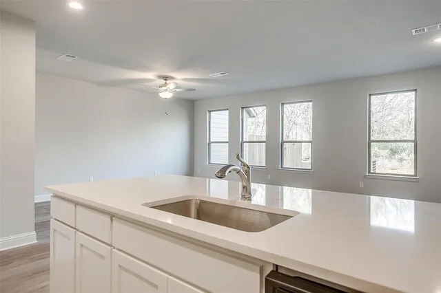 a kitchen with a sink cabinets and window