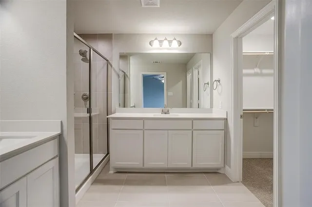 a bathroom with a sink a vanity a mirror and a shower