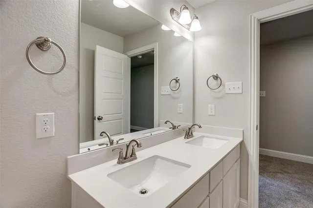 a bathroom with a sink vanity and a mirror