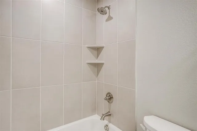 a bathroom with a shower and toilet