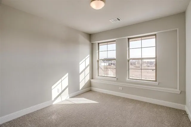 an empty room with windows and closet