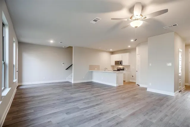 a view of kitchen with granite countertop cabinets and refrigerator