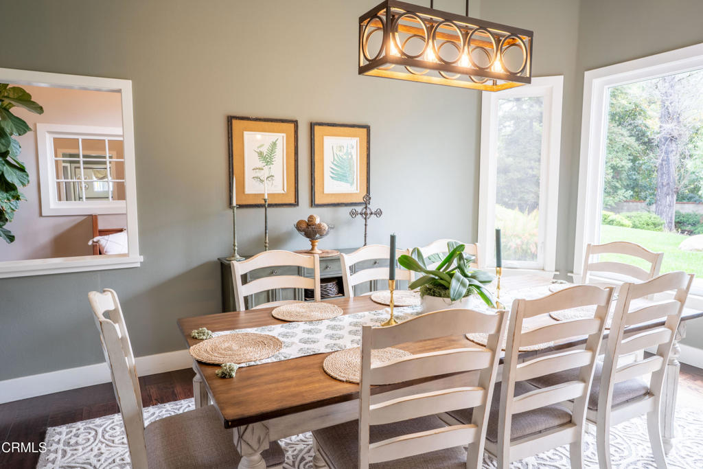 12075 East Pradera Road Camarillo, CA 93012 - Photo 11 of 54 a view of a dining room with furniture a chandelier and wooden floor