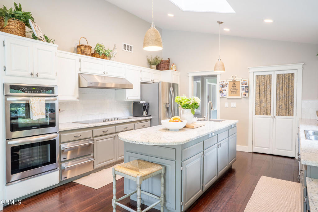 12075 East Pradera Road Camarillo, CA 93012 - Photo 17 of 54 a kitchen with a sink stove and wooden floor
