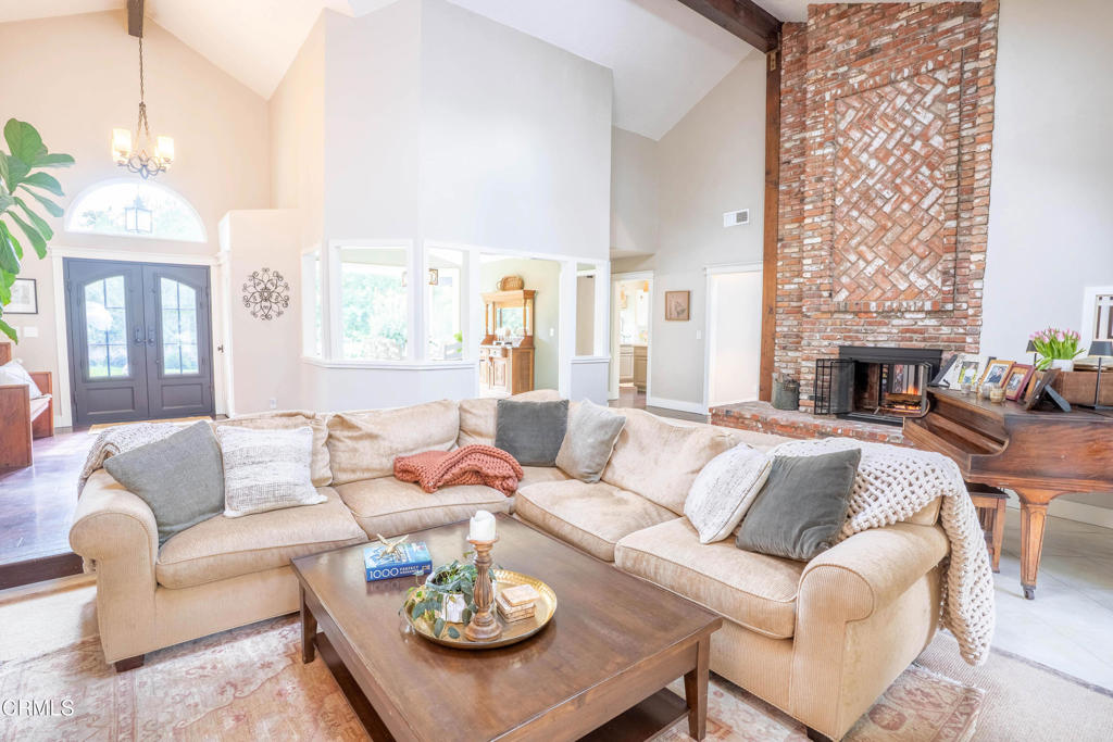 12075 East Pradera Road Camarillo, CA 93012 - Photo 18 of 54 a living room with furniture fireplace and a chandelier