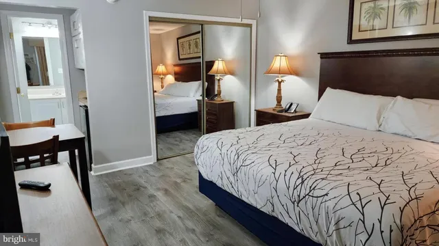 a bedroom with a bed and a lamp on the table