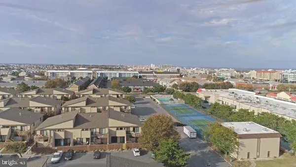 an aerial view of residential houses with city view