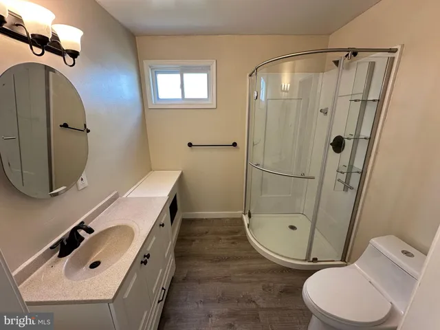 a bathroom with a sink mirror vanity and toilet