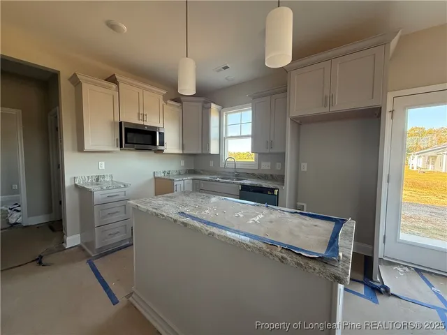 a kitchen with a sink appliances and cabinets