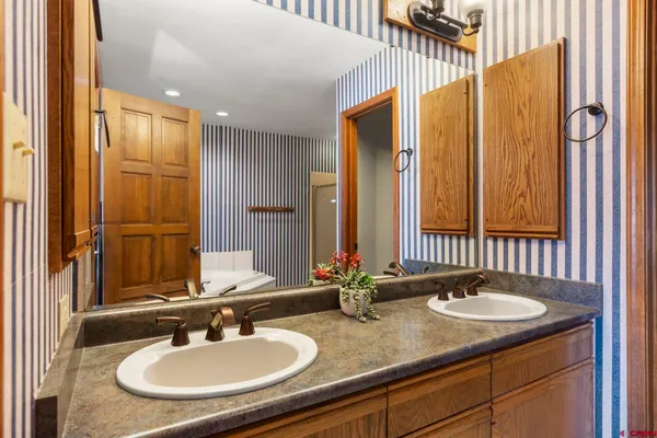 a bathroom with a sink double vanity and a mirror