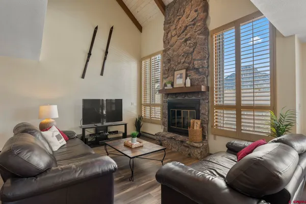 a living room with furniture a fireplace and a flat screen tv