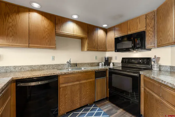 a kitchen with a sink stove and microwave
