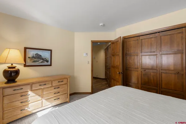 a bedroom with a bed and a dresser