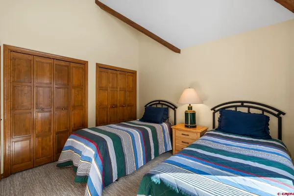 a bedroom with double bed and a window