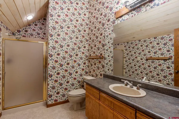 a bathroom with a sink toilet and shower