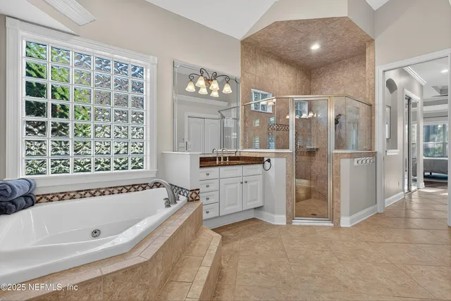 a living room with furniture a large window and flat screen tv