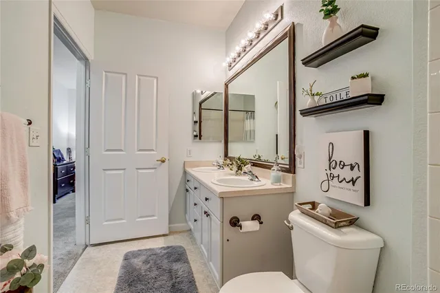 a living room with furniture a flat screen tv and a window