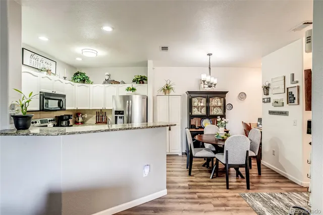 a kitchen with stainless steel appliances granite countertop a refrigerator and microwave