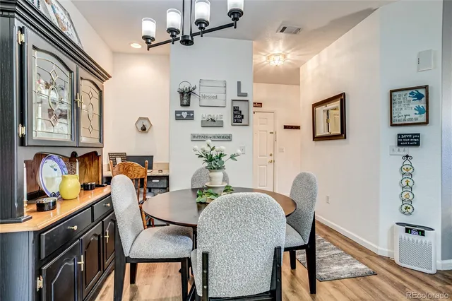 a dining room with furniture and wooden floor