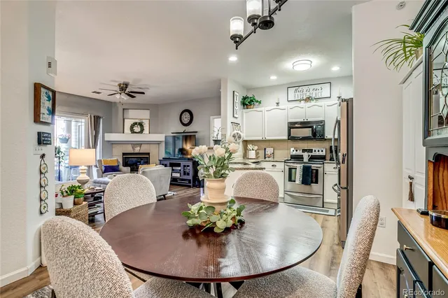 a living room with stainless steel appliances kitchen island furniture and a view of kitchen