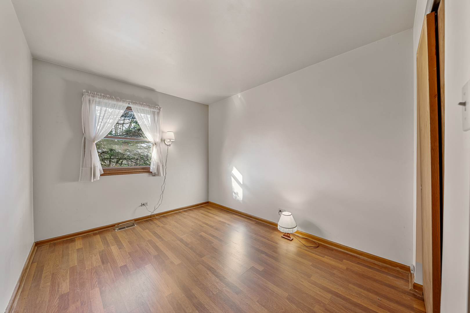 19929 South Schoolhouse Road Mokena, IL 60448 - Photo 10 of 15 an empty room with wooden floor and windows