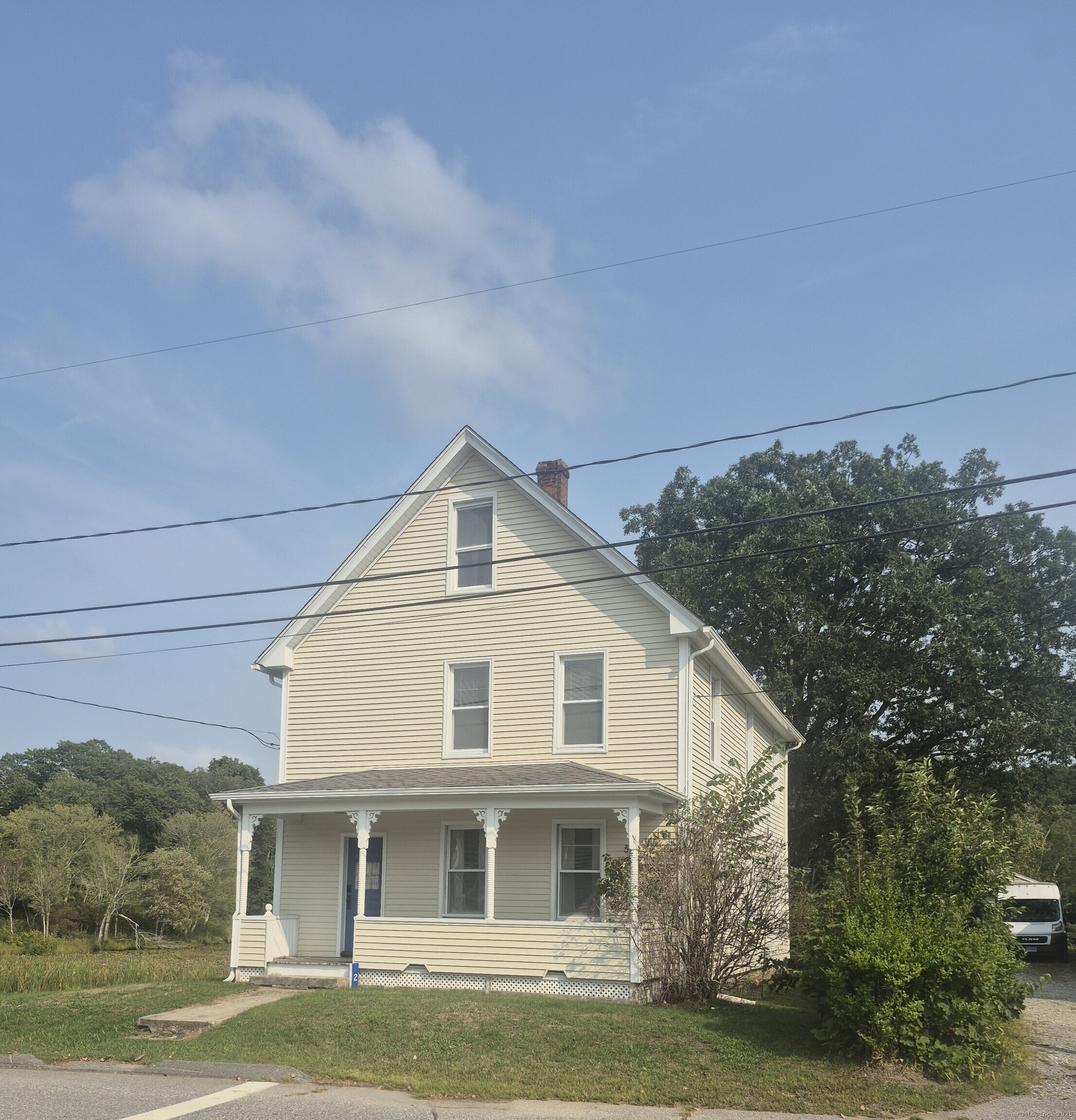 2 Blissville Road, Unit 2 Lisbon, CT 06351 - Photo 1 of 1 a view of a white house next to a yard with big trees