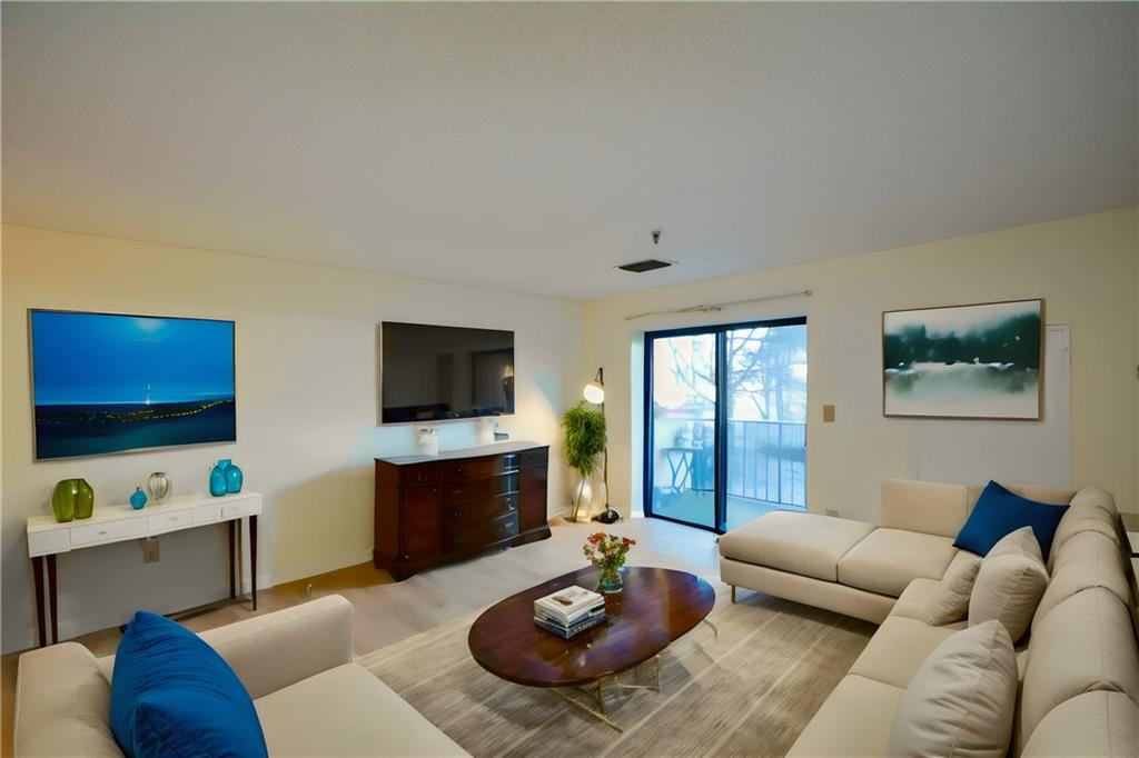 300 Johnson Ferry Road, Unit B109 Sandy Springs, GA 30328 - Photo 1 of 1 a living room with furniture and a flat screen tv