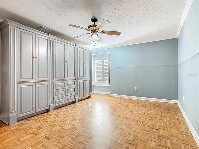 a view of a livingroom with a ceiling fan and window