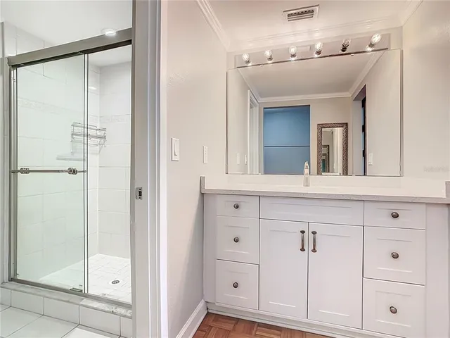 a bathroom with a shower sink and mirror
