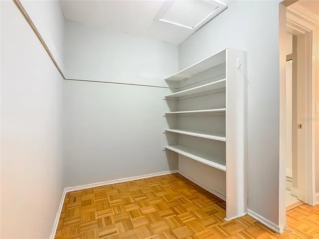 a view of a room with shelf on the wall
