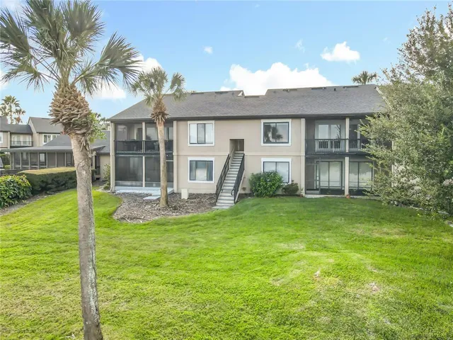 a view of a house with a yard patio and swimming pool