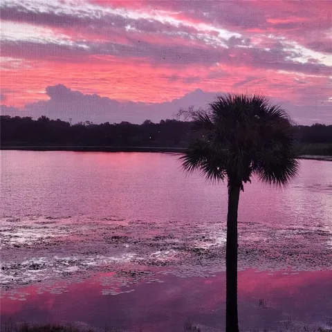 a view of lake with sunset