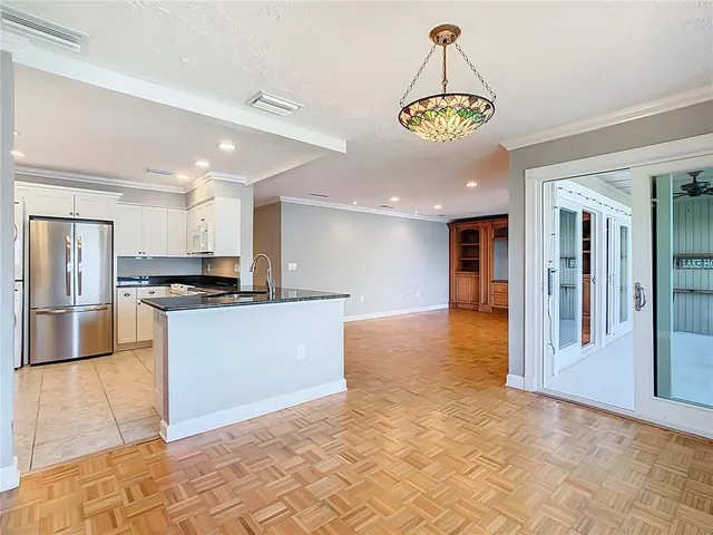 a view of kitchen with stainless steel appliances granite countertop a stove and a refrigerator