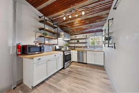a kitchen with sink cabinets and white appliances