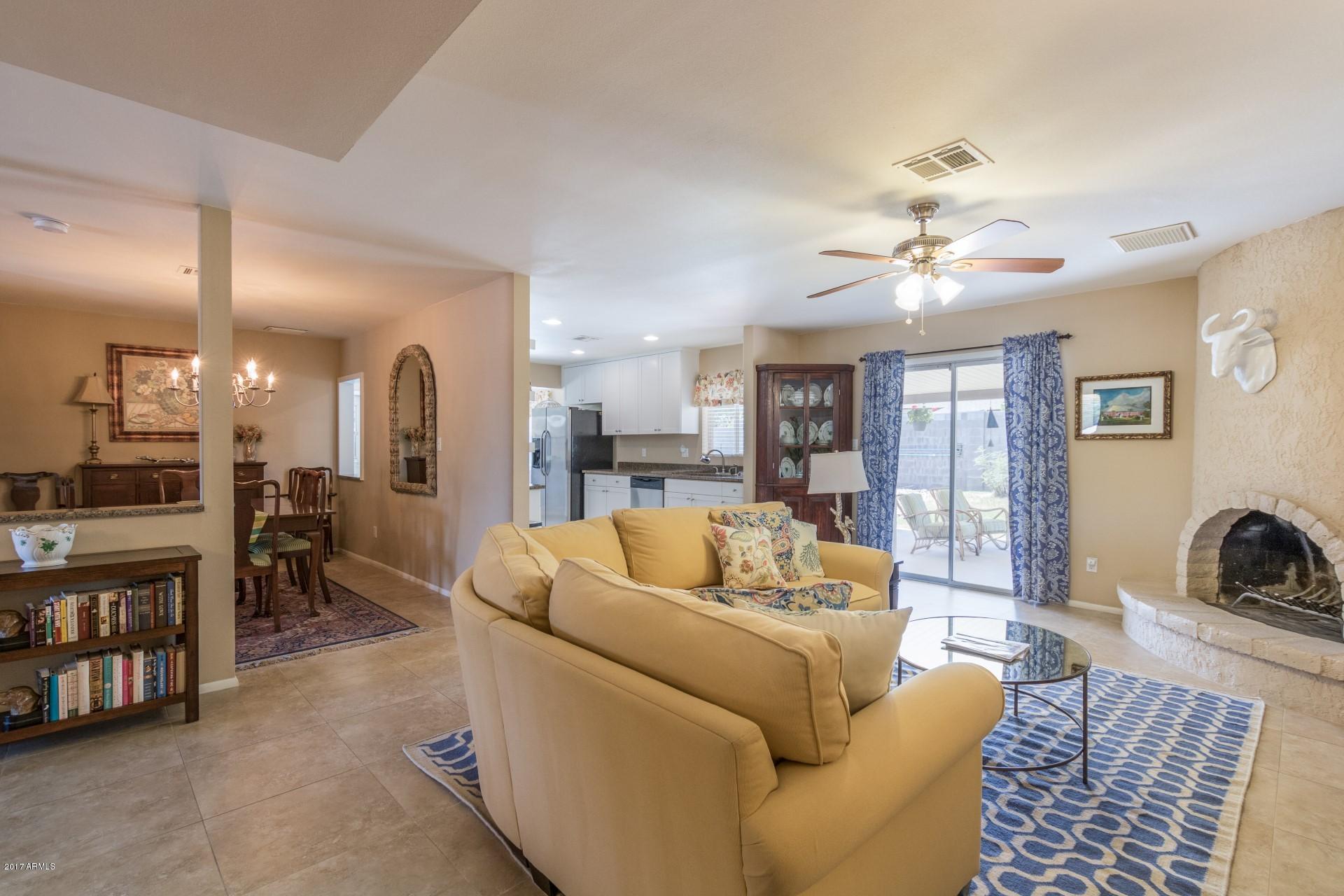 3717 East Yucca Street Phoenix, AZ 85028 - Photo 11 of 36 a living room with furniture and a chandelier