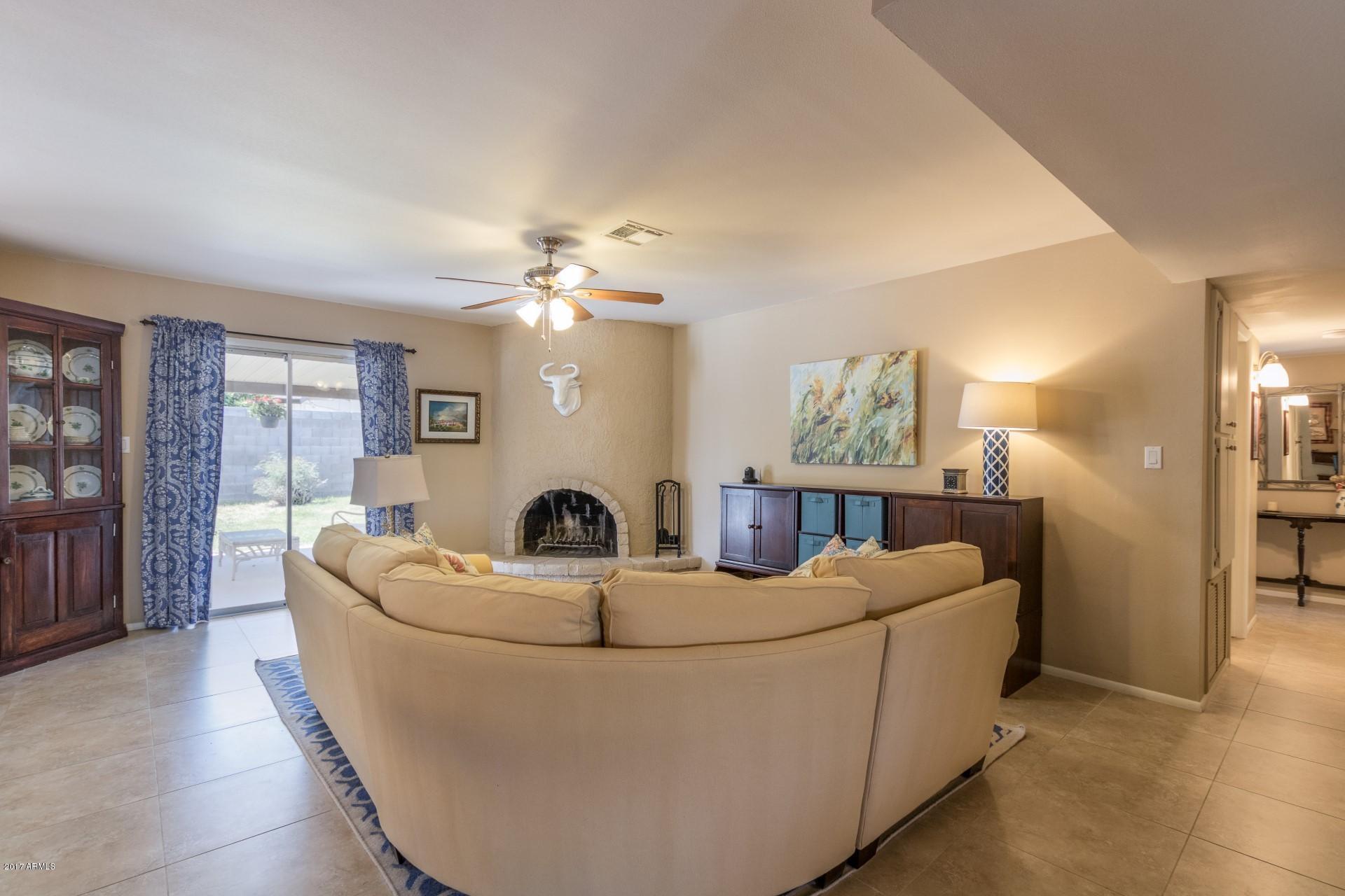 3717 East Yucca Street Phoenix, AZ 85028 - Photo 12 of 36 a living room with furniture and a chandelier