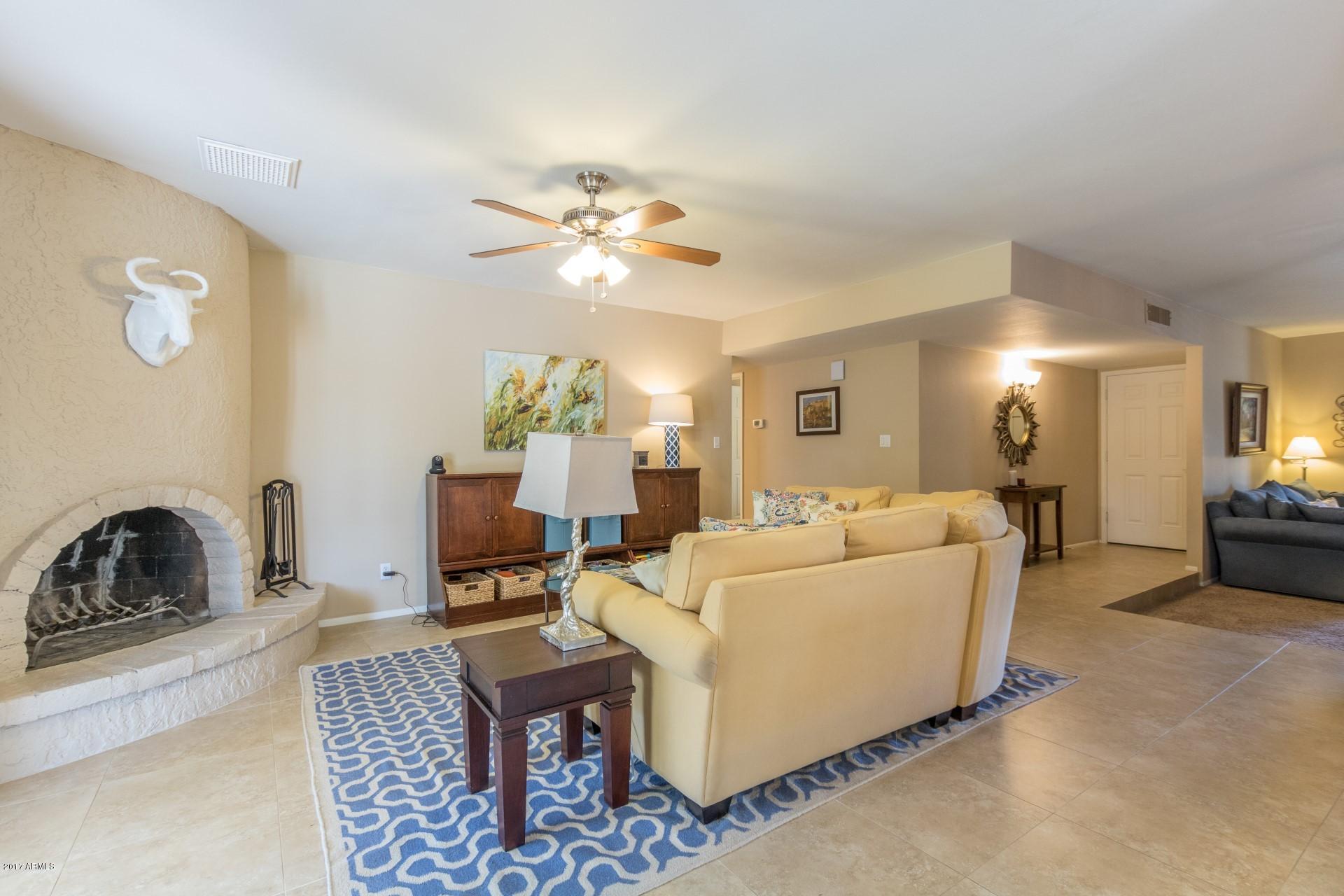 3717 East Yucca Street Phoenix, AZ 85028 - Photo 15 of 36 a living room with furniture and a chandelier
