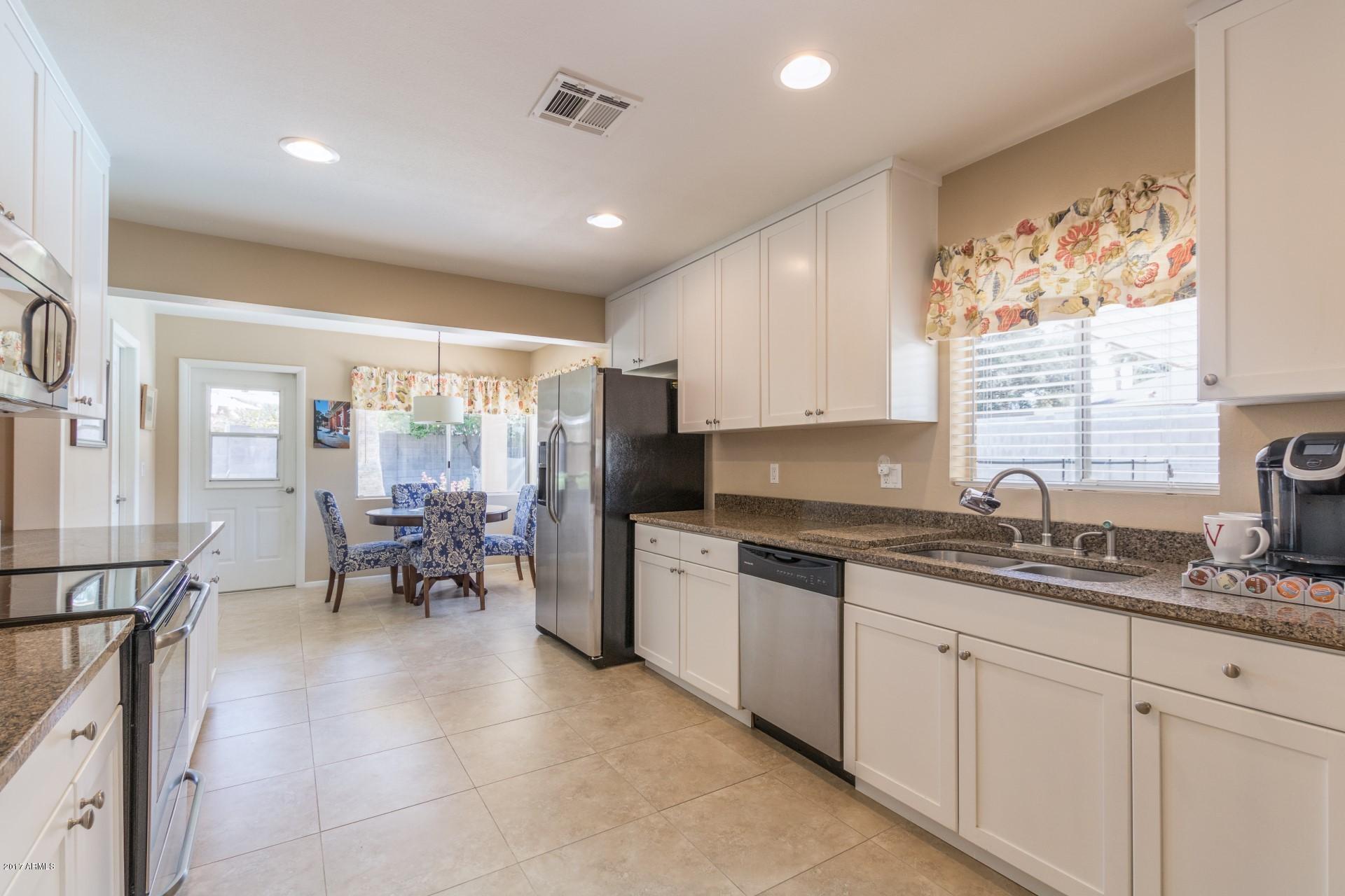 3717 East Yucca Street Phoenix, AZ 85028 - Photo 17 of 36 a kitchen with sink cabinets and window