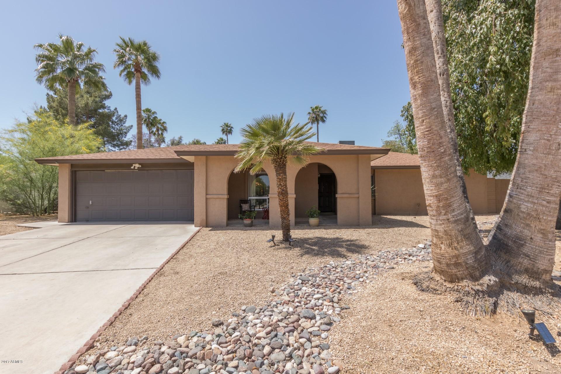 3717 East Yucca Street Phoenix, AZ 85028 - Photo 2 of 36 a view of a house with a yard and garage