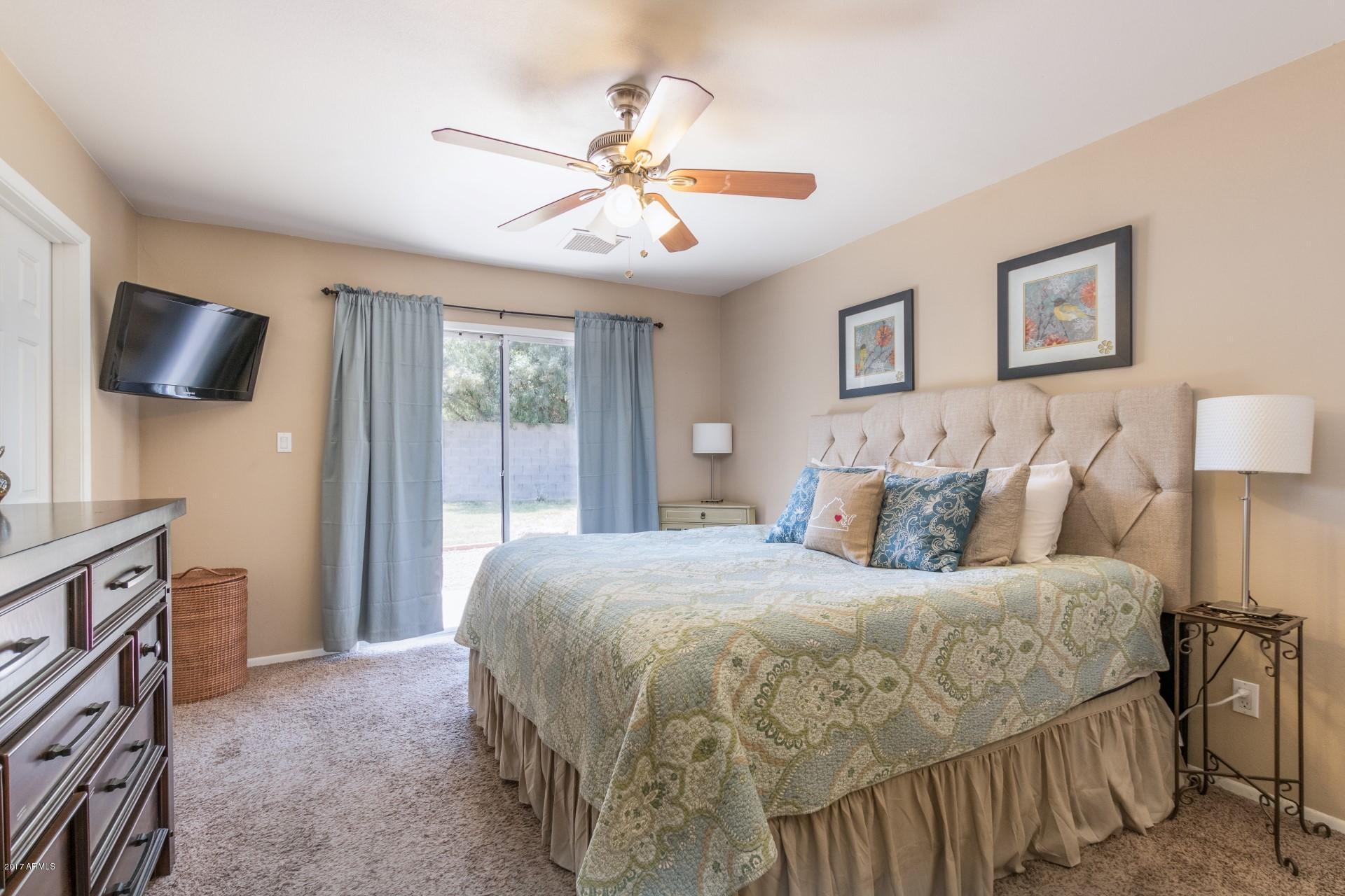 3717 East Yucca Street Phoenix, AZ 85028 - Photo 21 of 36 a bedroom with a bed and a flat screen tv