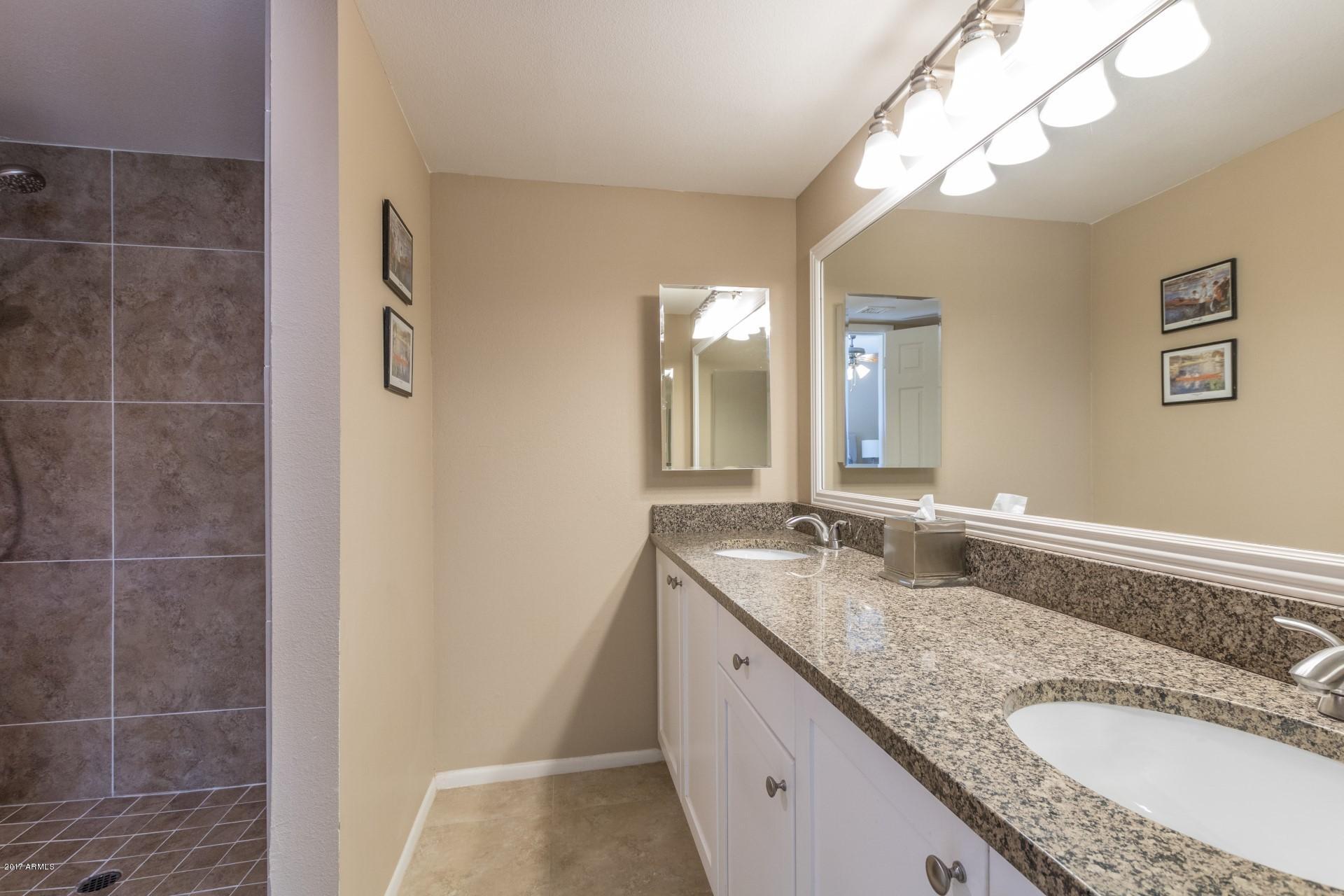 3717 East Yucca Street Phoenix, AZ 85028 - Photo 23 of 36 a bathroom with a granite countertop double vanity sink and mirror