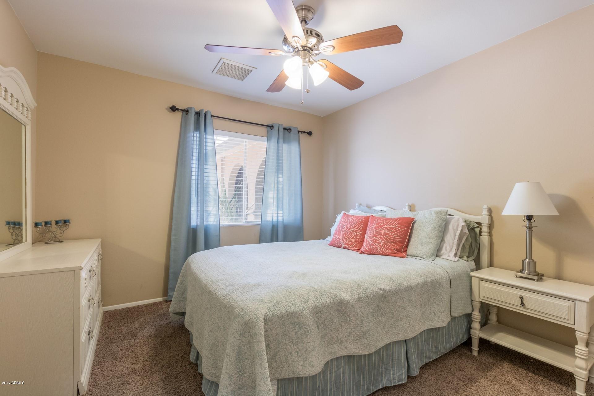 3717 East Yucca Street Phoenix, AZ 85028 - Photo 24 of 36 a bedroom with a bed and a chandelier