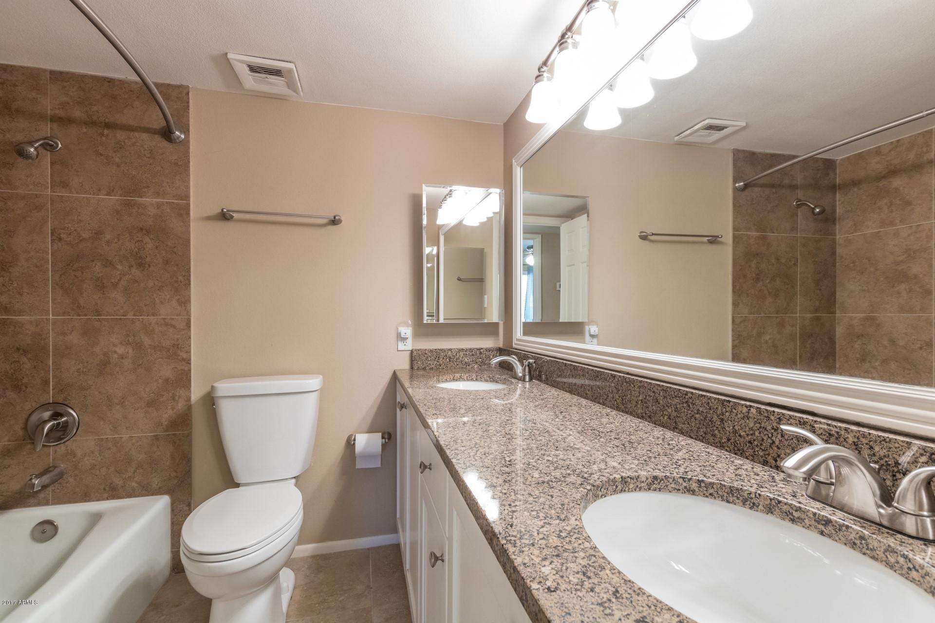 3717 East Yucca Street Phoenix, AZ 85028 - Photo 25 of 36 a bathroom with a granite countertop sink toilet and shower