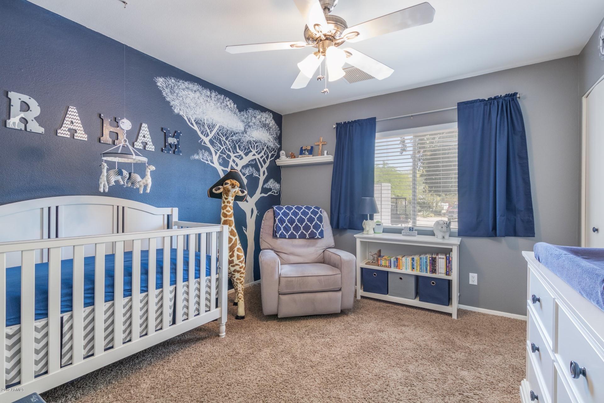 3717 East Yucca Street Phoenix, AZ 85028 - Photo 26 of 36 a bedroom with furniture and a chandelier