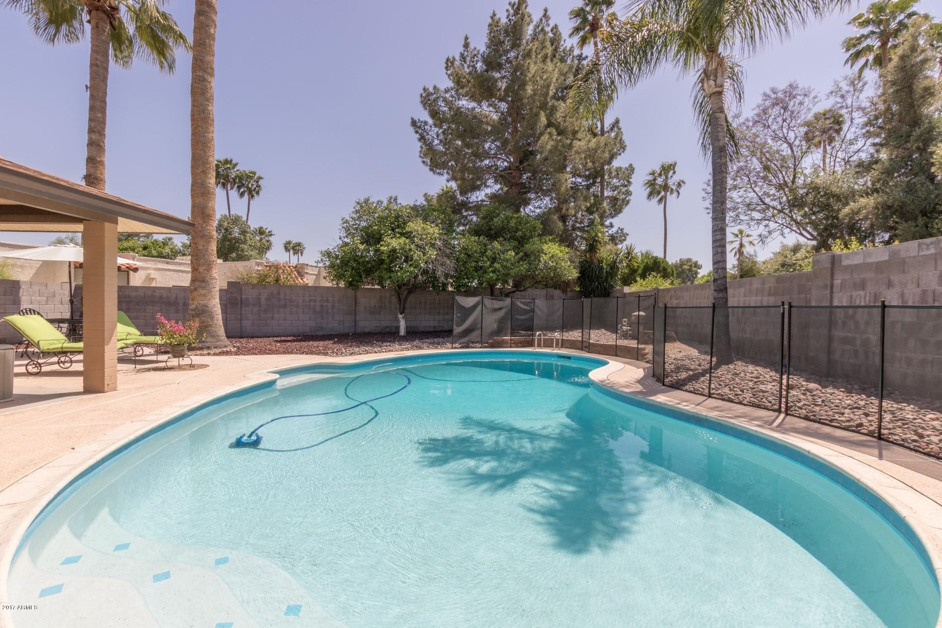 3717 East Yucca Street Phoenix, AZ 85028 - Photo 30 of 36 a swimming pool with outdoor seating and yard
